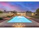 Gorgeous backyard pool with desert landscaping, stylish outdoor lighting and covered patio in the background at 863 W Kiva Ave, Mesa, AZ 85210