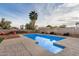 Relaxing backyard pool with rock landscaping, a palm tree, and a privacy fence at 863 W Kiva Ave, Mesa, AZ 85210