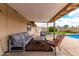 Relaxing covered patio with comfortable seating and views of the backyard and inviting pool at 8637 E Weldon Ave, Scottsdale, AZ 85251