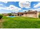 Expansive backyard showcasing a beautiful swimming pool, well-maintained lawn, and relaxing outdoor space at 8637 E Weldon Ave, Scottsdale, AZ 85251