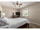 Comfortable bedroom with ceiling fan, television, wood-look flooring, and natural light from the window at 8637 E Weldon Ave, Scottsdale, AZ 85251