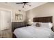 Bedroom featuring a dresser, ceiling fan, closet, and a plush queen bed with a side table at 8637 E Weldon Ave, Scottsdale, AZ 85251