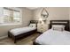 Stylish bedroom with twin beds, matching dressers, mirror, and wood-look flooring at 8637 E Weldon Ave, Scottsdale, AZ 85251