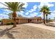 Charming single-story home showcasing desert landscaping and inviting curb appeal with mature palm trees at 8637 E Weldon Ave, Scottsdale, AZ 85251