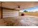 Large, open two-car garage featuring a white garage door with an automatic opener and plenty of space at 8637 E Weldon Ave, Scottsdale, AZ 85251