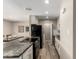 Modern kitchen with white cabinets, granite countertops, stainless steel appliances, and an eat in counter at 8637 E Weldon Ave, Scottsdale, AZ 85251