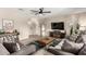 A stylish living room features wood-look flooring, comfortable seating, and an entertainment center at 8637 E Weldon Ave, Scottsdale, AZ 85251