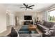 Cozy living room with hardwood floors, a ceiling fan, and a view to the backyard through a bright window at 8637 E Weldon Ave, Scottsdale, AZ 85251