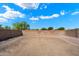 Unlandscaped backyard surrounded by a brick wall and desert landscaping at 8708 S 50Th Ln, Laveen, AZ 85339