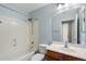 A light and bright bathroom featuring a shower-tub combo, toilet, and a vanity sink at 8708 S 50Th Ln, Laveen, AZ 85339
