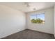 The bedroom has neutral paint, carpeting and a window bringing in outside light at 8708 S 50Th Ln, Laveen, AZ 85339