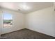 The bedroom features carpeted floors, neutral paint and a view out of the window at 8708 S 50Th Ln, Laveen, AZ 85339