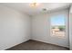 The bedroom has neutral paint, carpeting and a window bringing in outside light at 8708 S 50Th Ln, Laveen, AZ 85339