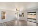 Open floor plan with wood look floors, ceiling fan and large windows at 8708 S 50Th Ln, Laveen, AZ 85339