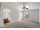 Large carpeted main bedroom with ceiling fan and ensuite bathroom at 8708 S 50Th Ln, Laveen, AZ 85339