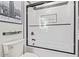 Bathroom featuring subway tile and framed glass doors to tub and shower at 8989 N Gainey Center Dr # 231, Scottsdale, AZ 85258