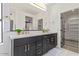 Elegant bathroom with double vanity, dark cabinetry, and quartz countertops offering style and functionality at 8989 N Gainey Center Dr # 231, Scottsdale, AZ 85258