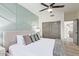 Bedroom with a patterned accent wall, ceiling fan, and hardwood floors at 8989 N Gainey Center Dr # 231, Scottsdale, AZ 85258