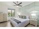 Bedroom with a patterned accent wall, ceiling fan, and hardwood floors at 8989 N Gainey Center Dr # 231, Scottsdale, AZ 85258