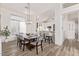 Dining room featuring a dining table with chairs, view into kitchen, and contemporary light fixture at 8989 N Gainey Center Dr # 231, Scottsdale, AZ 85258