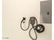 Garage equipped with a Grizzl-E electric vehicle charger on the wall at 8989 N Gainey Center Dr # 231, Scottsdale, AZ 85258