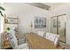 Bright home office space featuring a wooden desk, white chairs, and built-in shelving at 8989 N Gainey Center Dr # 231, Scottsdale, AZ 85258