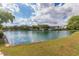 Beautiful lake view with lush green grass, trees, and buildings in the background at 8989 N Gainey Center Dr # 231, Scottsdale, AZ 85258