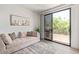 Cozy living room with a large window, sliding glass door, and hardwood floors at 8989 N Gainey Center Dr # 231, Scottsdale, AZ 85258