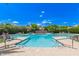 Beautiful community pool with poolside furniture, shaded area, and lush landscaping at 8989 N Gainey Center Dr # 231, Scottsdale, AZ 85258