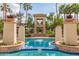Luxury pool area featuring clear blue water, palm trees, and a decorative entrance at 8989 N Gainey Center Dr # 231, Scottsdale, AZ 85258
