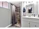 Updated bathroom with modern vanity, decorative mirror, and tiled shower featuring stylish accents at 903 N Revere St # F, Mesa, AZ 85201