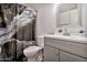 Cozy bathroom featuring a stylish shower curtain, vanity and a framed mirror at 903 N Revere St # F, Mesa, AZ 85201