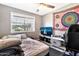 Comfortable bedroom with natural light, ceiling fan, and calming gray walls at 903 N Revere St # F, Mesa, AZ 85201