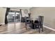 Dining area featuring modern furnishings, wood-look flooring, and sliding glass doors at 903 N Revere St # F, Mesa, AZ 85201