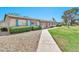 Attractive exterior of single-story condo featuring tidy landscaping and pathway leading to the entrance at 903 N Revere St # F, Mesa, AZ 85201