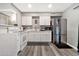 Well-lit kitchen featuring white cabinets, stainless steel refrigerator, and modern appliances at 903 N Revere St # F, Mesa, AZ 85201