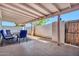 Tiled and covered patio space with seating, open to the backyard, perfect for entertaining at 903 N Revere St # F, Mesa, AZ 85201