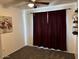 The bedroom has nice carpet and red curtains that block out light at 948 S Alma School Rd # 115, Mesa, AZ 85210