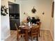 Cozy dining area with wooden table and gray kitchen in the background at 948 S Alma School Rd # 115, Mesa, AZ 85210