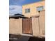 Charming home featuring a private entrance gate and stucco exterior with a gazebo visible over the fence at 948 S Alma School Rd # 115, Mesa, AZ 85210