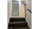 A staircase with carpeted steps and a dark metal railing leads to the upper level at 948 S Alma School Rd # 115, Mesa, AZ 85210