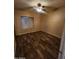 Bedroom featuring laminate flooring, a ceiling fan, and a window at 11233 W Olive Dr, Avondale, AZ 85392
