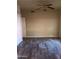 Bedroom with wood-look tile flooring and ceiling fan at 11233 W Olive Dr, Avondale, AZ 85392