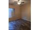 Bedroom featuring wood-look tile flooring and ample natural light at 11233 W Olive Dr, Avondale, AZ 85392