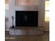 Close up of a fireplace area featuring decorative tiled floors and a sleek black metal screen at 11233 W Olive Dr, Avondale, AZ 85392