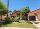 Beautiful one-story home with stone accents, arched entryway, and an attached two-car garage in a well-kept front yard at 11233 W Olive Dr, Avondale, AZ 85392