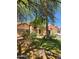 Charming single-story home featuring a stone facade and well-maintained landscaping in a lush, green front yard at 11233 W Olive Dr, Avondale, AZ 85392