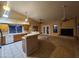 Open-concept kitchen with a breakfast bar, stainless steel appliances, and updated tile at 11233 W Olive Dr, Avondale, AZ 85392