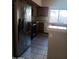 Spacious kitchen featuring stainless steel refrigerator and tile flooring at 11233 W Olive Dr, Avondale, AZ 85392