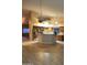 Open-concept kitchen with a breakfast bar, stainless steel appliances, and tile floors at 11233 W Olive Dr, Avondale, AZ 85392